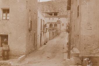 El carrer del Call el 1928, amb façanes de pedra i finestres amb reixa.